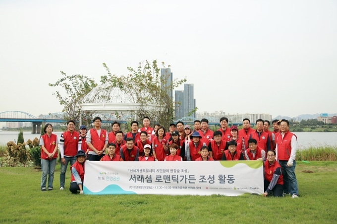 신세계센트럴시티 임직원들이 반포한강공원 서래섬 로맨틱가든 조성활동 기념촬영을 하고 있다